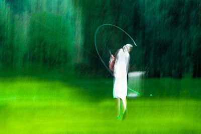 Man holding umbrella standing on land