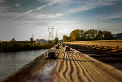 Close-up of railroad track against sky during sunset