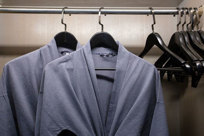 Close-up of clothes hanging on rack in shelf