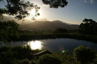 Scenic view of lake against sky during sunset