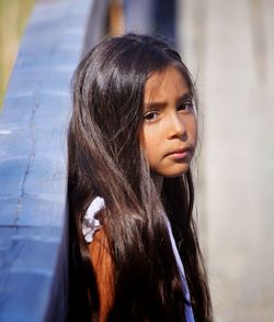 Portrait of girl standing by railing