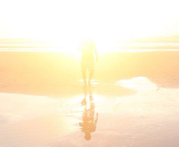 Woman at beach during sunset