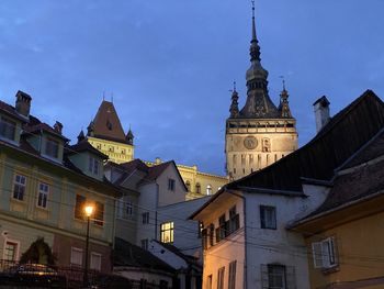 Low angle view of illuminated buildings against sky at dusk