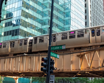 Low angle view of train against buildings in city