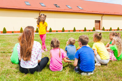 Group of people sitting on grassland