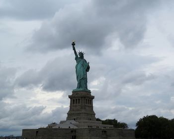 Low angle view of statue against cloudy sky