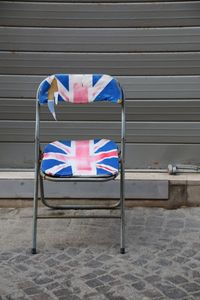 Run-down empty chair with british flag