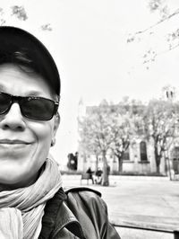 Portrait of young man wearing sunglasses against sky