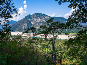 Scenic view of lake by mountains against sky