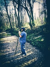 Full length of man standing in forest