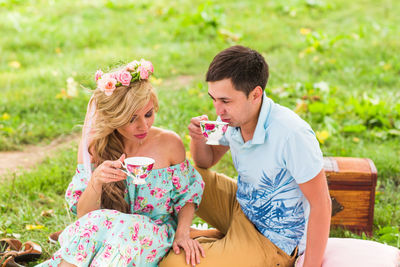 Young couple sitting outdoors