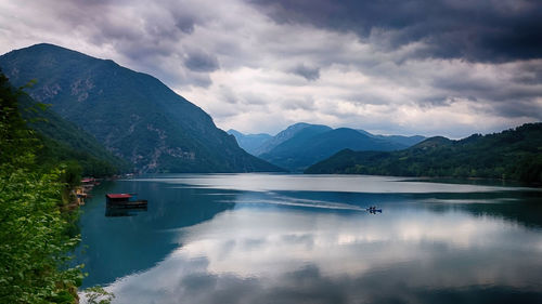 Scenic view of lake and mountains against sky