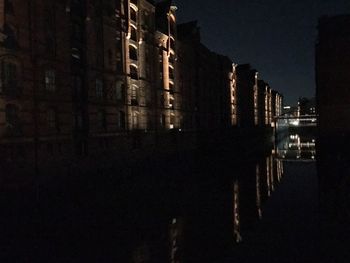 Illuminated city against sky at night