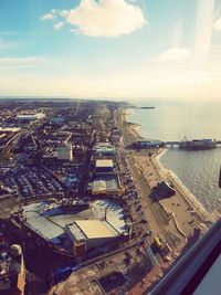 High angle view of buildings by sea against sky