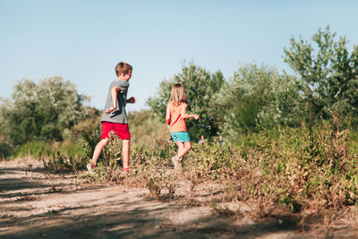 Siblings running on field