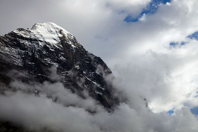 Low angle view of snowcapped mountains against sky