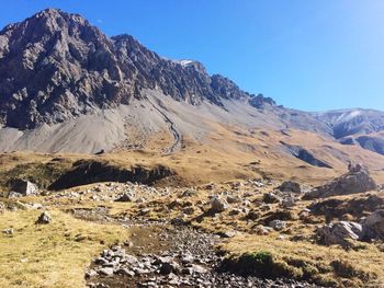 Scenic view of mountains against clear blue sky
