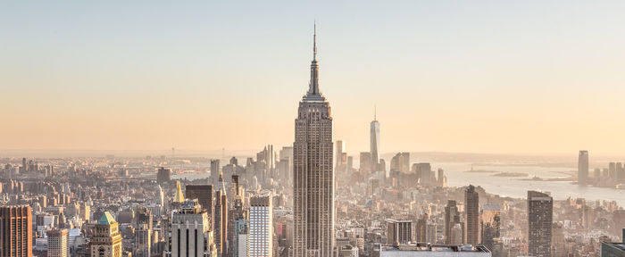 Modern buildings in city against clear sky