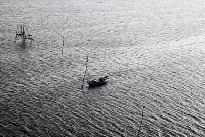 High angle view of man on sailboat in sea