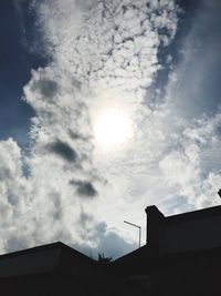 Low angle view of building against cloudy sky