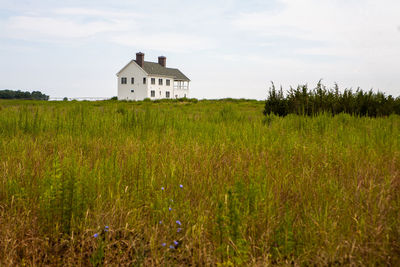 House on field against sky