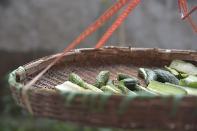 Close-up of bitter gourds in wicker basket