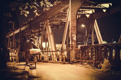 Rear view of man on bridge at night