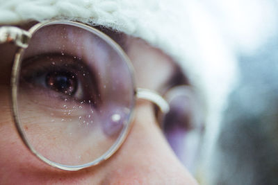 Extreme close-up of woman wearing eyeglasses while looking away outdoors