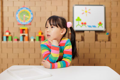 Portrait of boy playing with toy blocks at home