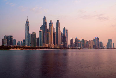 Modern buildings in city at sunset