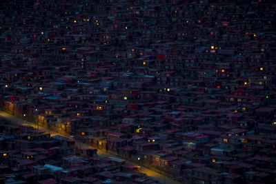 Illuminated cityscape against sky at night