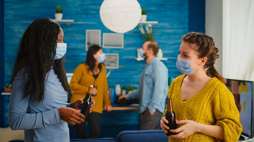 People wearing mask talking at home