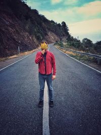 Rear view of man standing on road