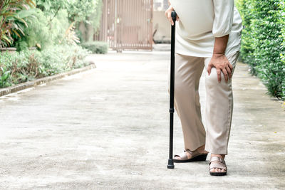 Low section of man standing on footpath