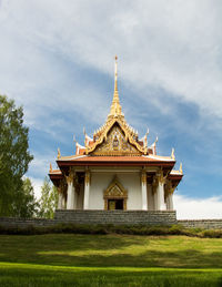 View of temple building against cloudy sky