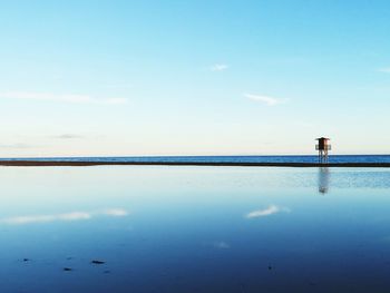 Scenic view of sea against blue sky