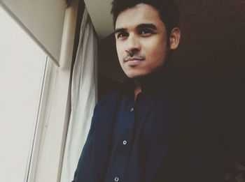 Low angle view of businessman standing by window