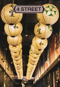 Low angle view of illuminated lanterns hanging at night
