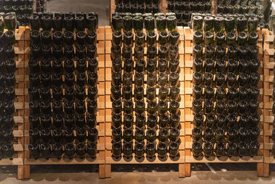 Close-up of wine bottles on rack