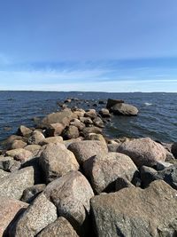 Rocks on beach against sky