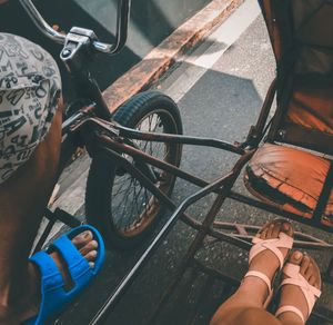 Low section of man riding bicycle on street