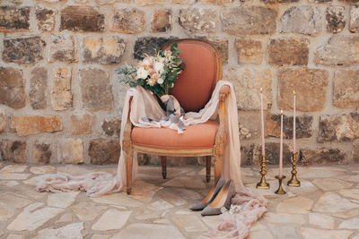 Potted plant on chair against wall