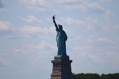 Low angle view of statue against cloudy sky