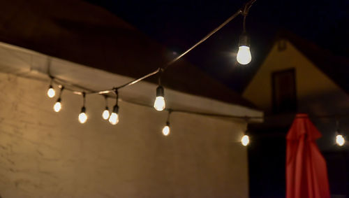 Low angle view of illuminated lights hanging from ceiling