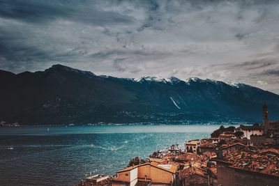 Scenic view of sea by buildings in town