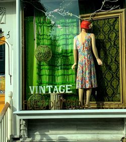 Rear view of woman standing by window