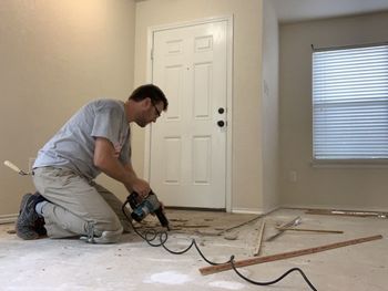 Side view of man drilling at home