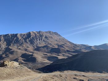 Scenic view of mountains against clear blue sky