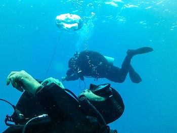 Low angle view of men swimming in sea