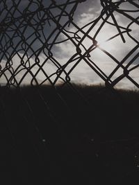 Chainlink fence against sky at dusk